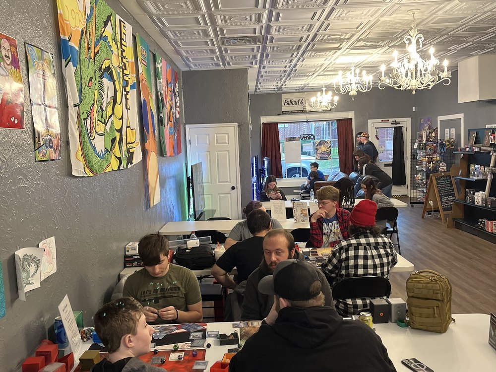 Players at tables under the tin ceiling and chandeliers
